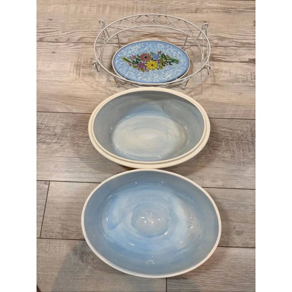 Temp-tations Ovenware by Tara Blue oval covered casserole dish with a metal stan